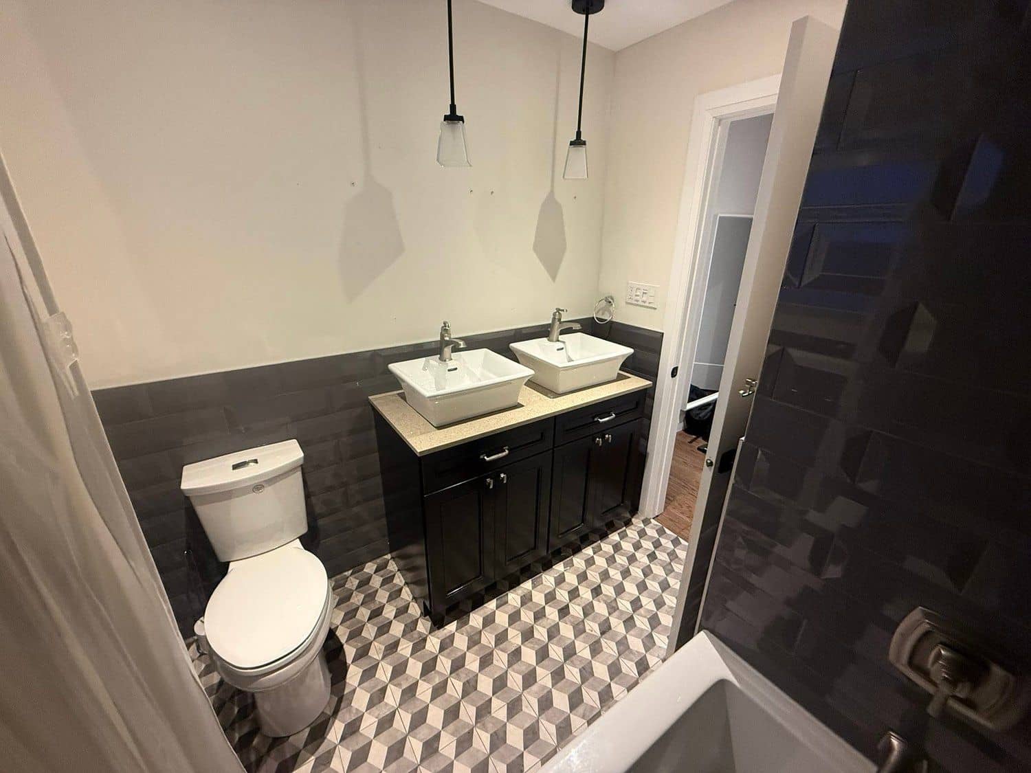 Modern bathroom with a double vanity and geometric tile floor