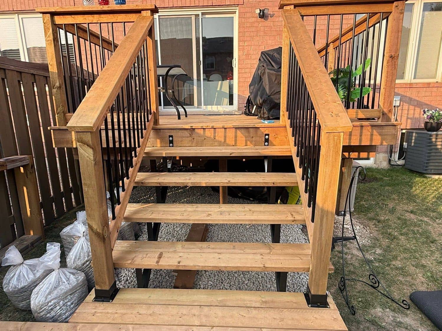 Newly built cedar deck with steps and steel-spindle railings