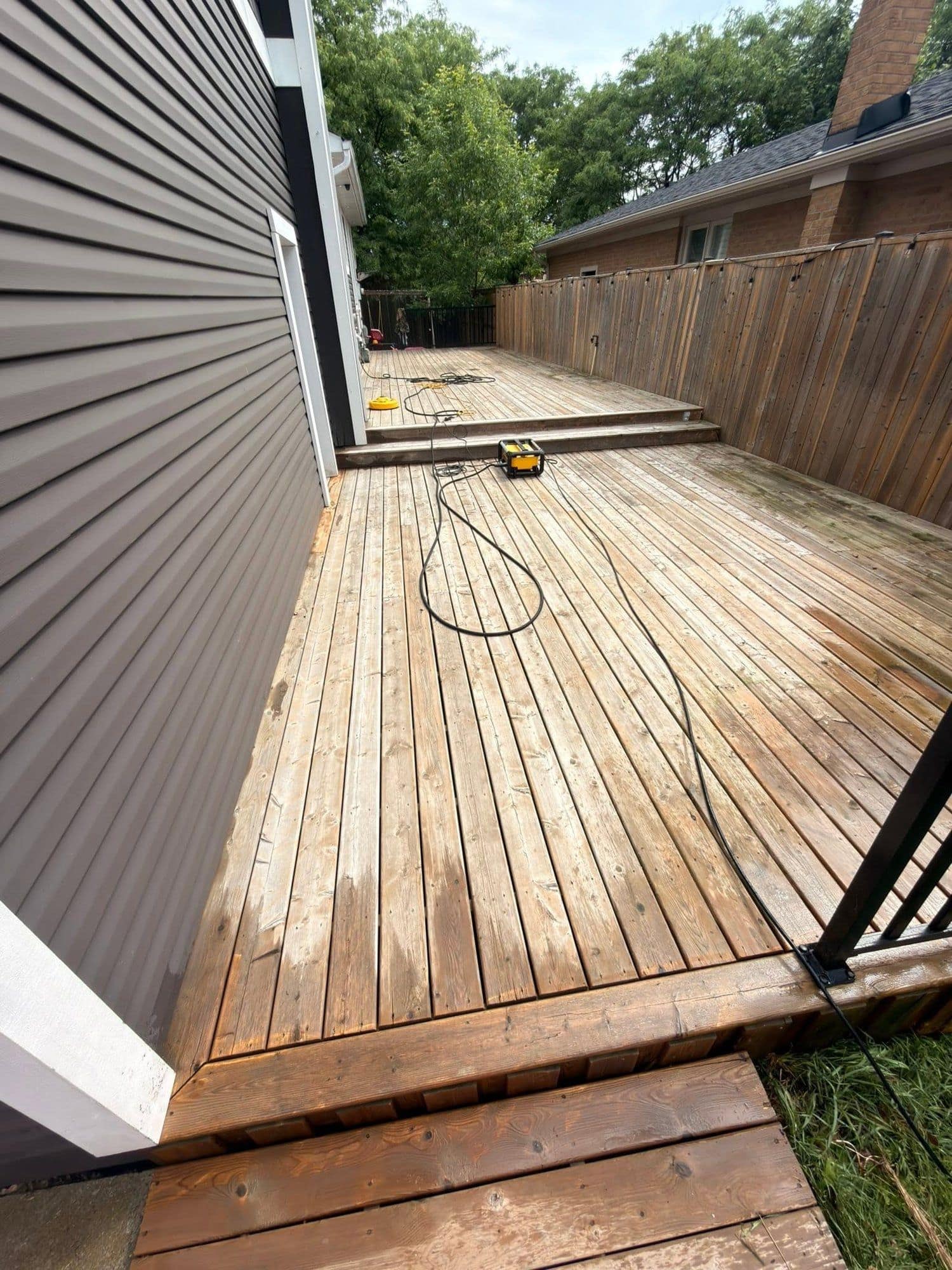 The same deck before restoration, weathered and grey